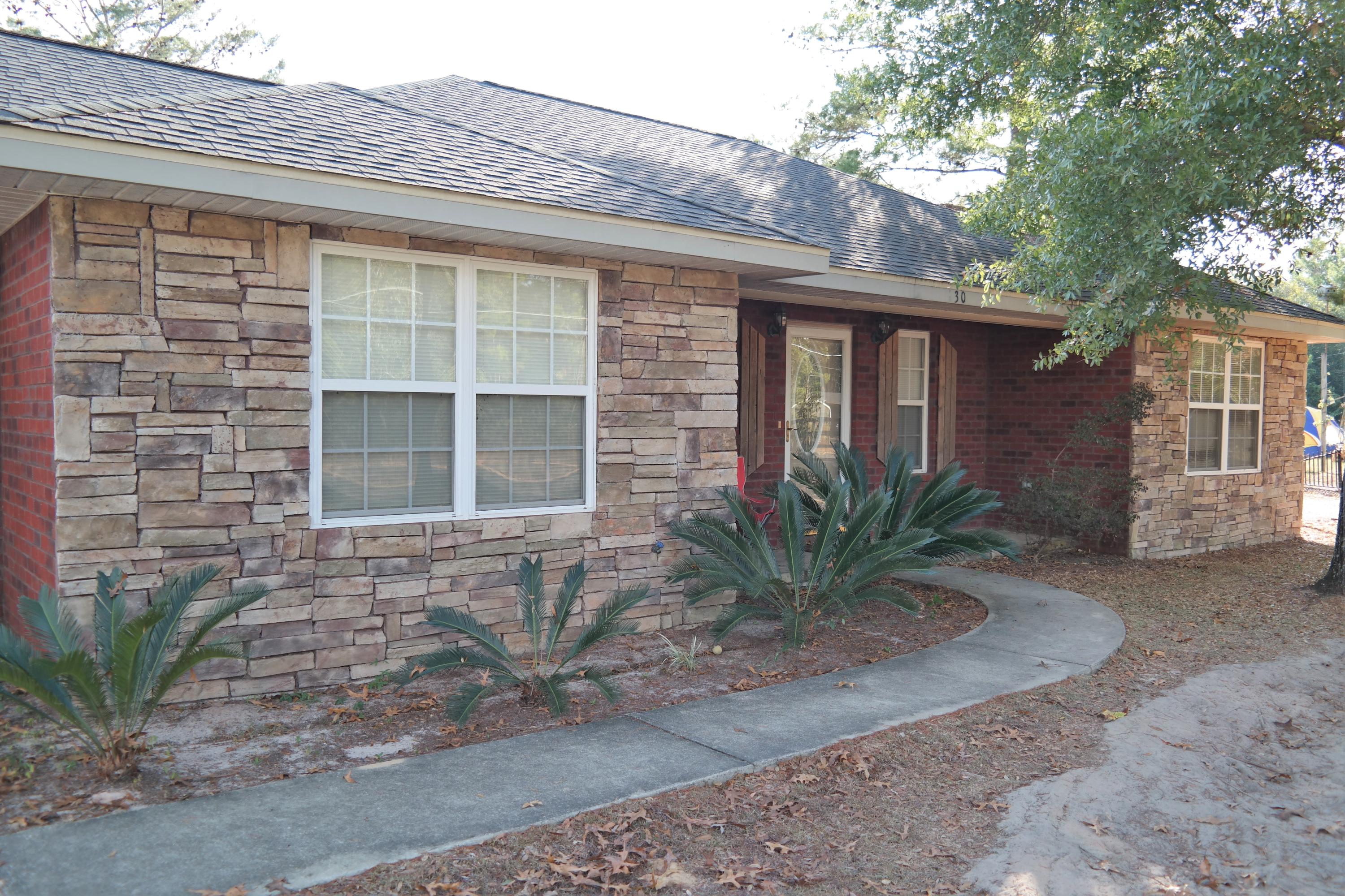 130 Crocus Avenue DeFuniak Springs, FL 32433 - Photo 2 of 24 a front view of a house with a yard