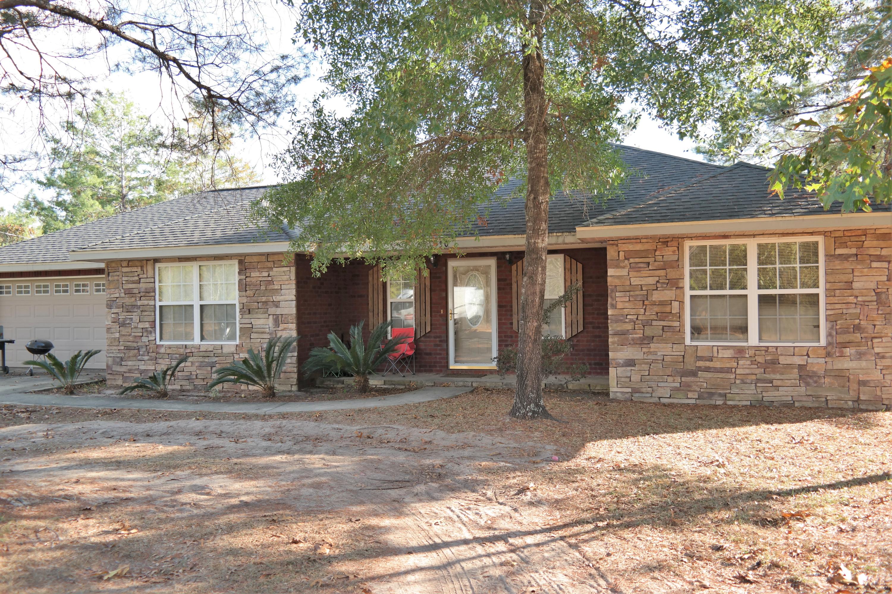 130 Crocus Avenue DeFuniak Springs, FL 32433 - Photo 24 of 24 a front view of a house with garden