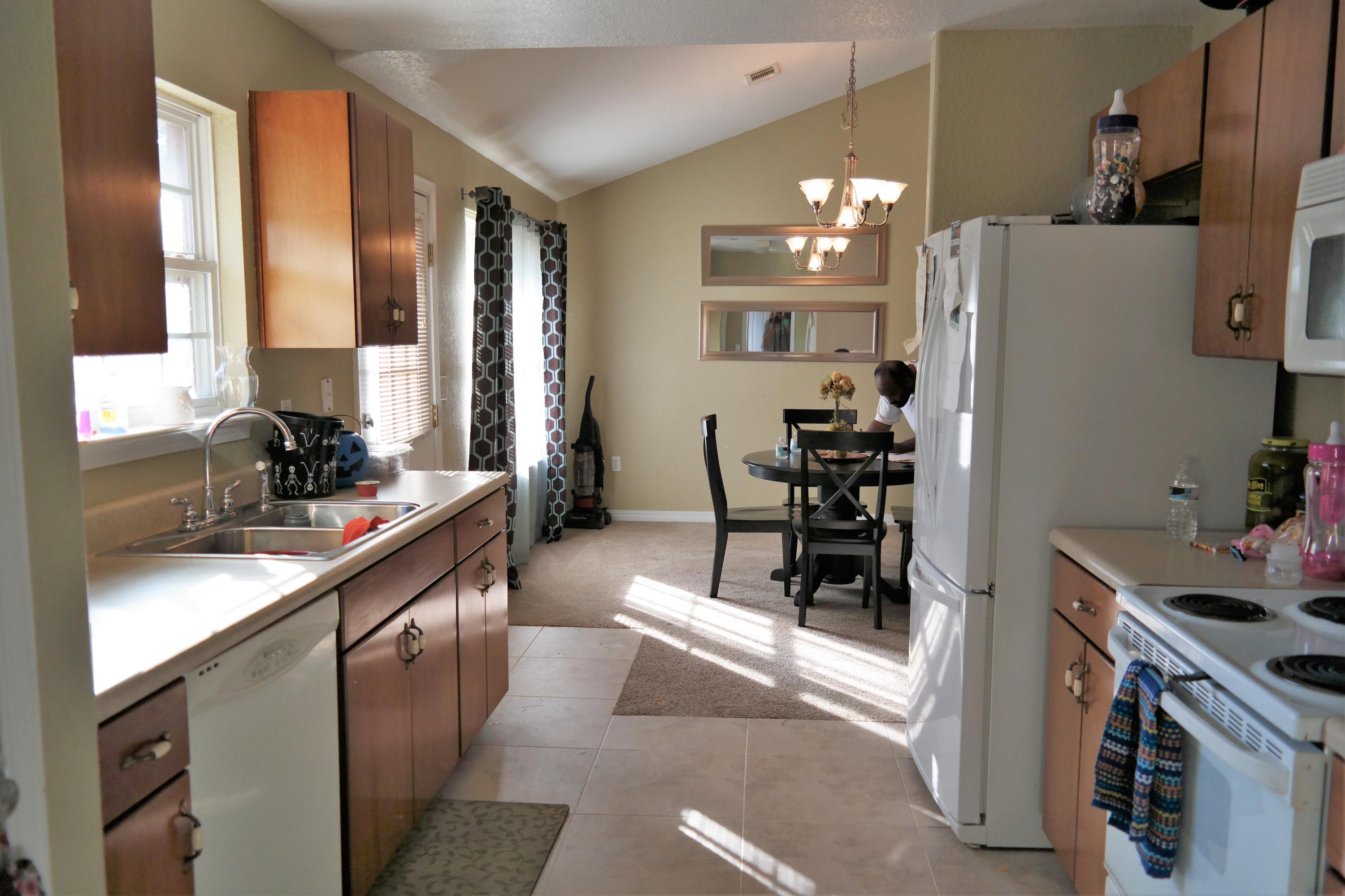 130 Crocus Avenue DeFuniak Springs, FL 32433 - Photo 7 of 24 a kitchen with refrigerator and cabinets