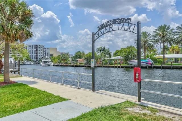 a street sign on a wall next to a road