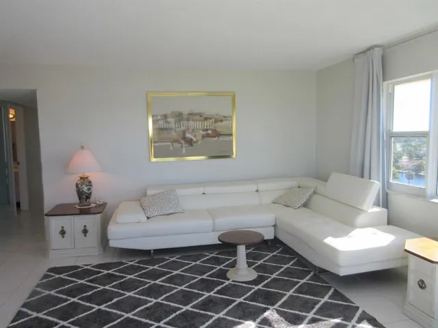 a living room with furniture a lamp and a window