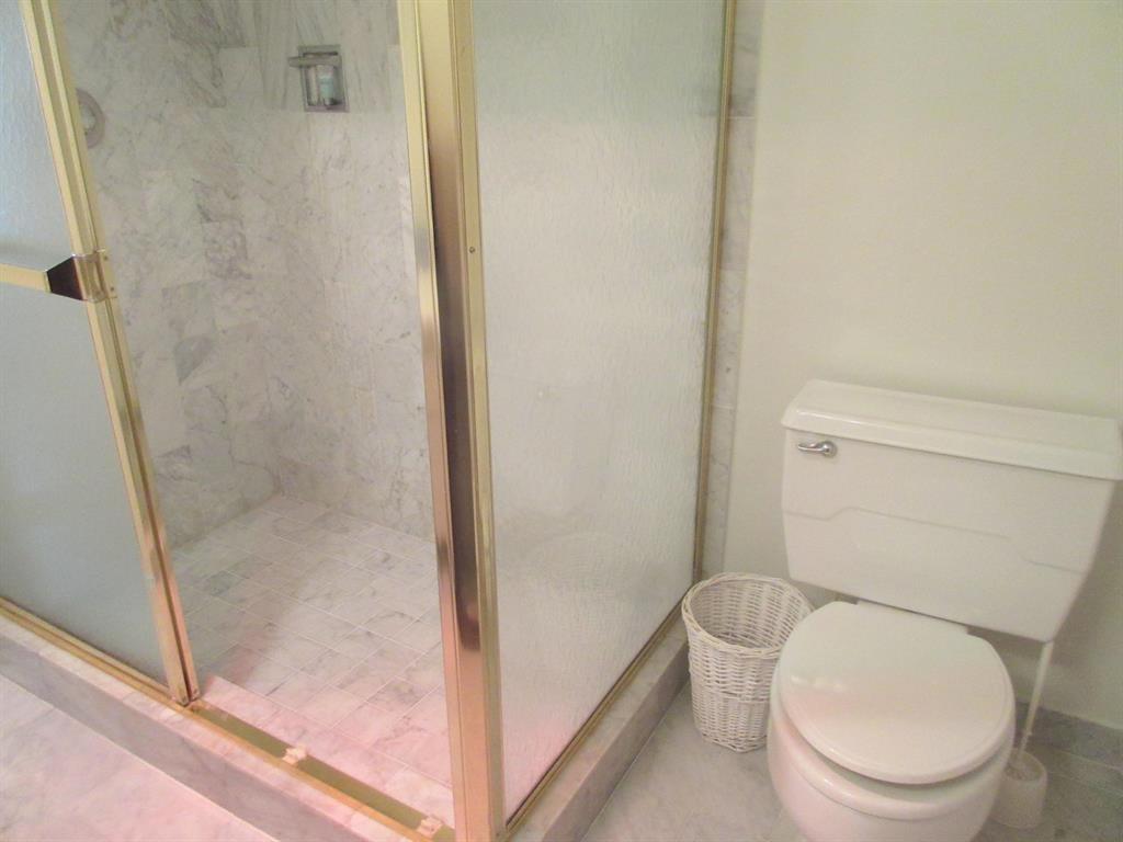 1200 Hibiscus Avenue, Unit 801 Pompano Beach, FL 33062 - Photo 7 of 12 a white toilet sitting next to a bath tub