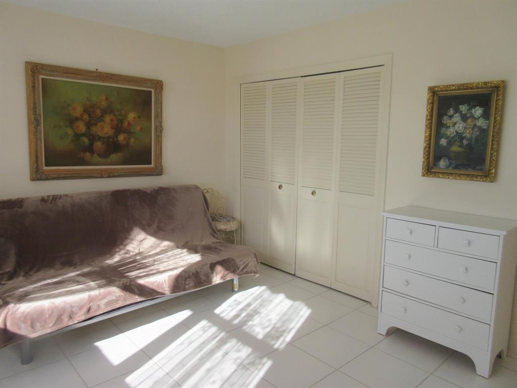1200 Hibiscus Avenue, Unit 801 Pompano Beach, FL 33062 - Photo 10 of 12 a bedroom with a bed and a painting on the wall