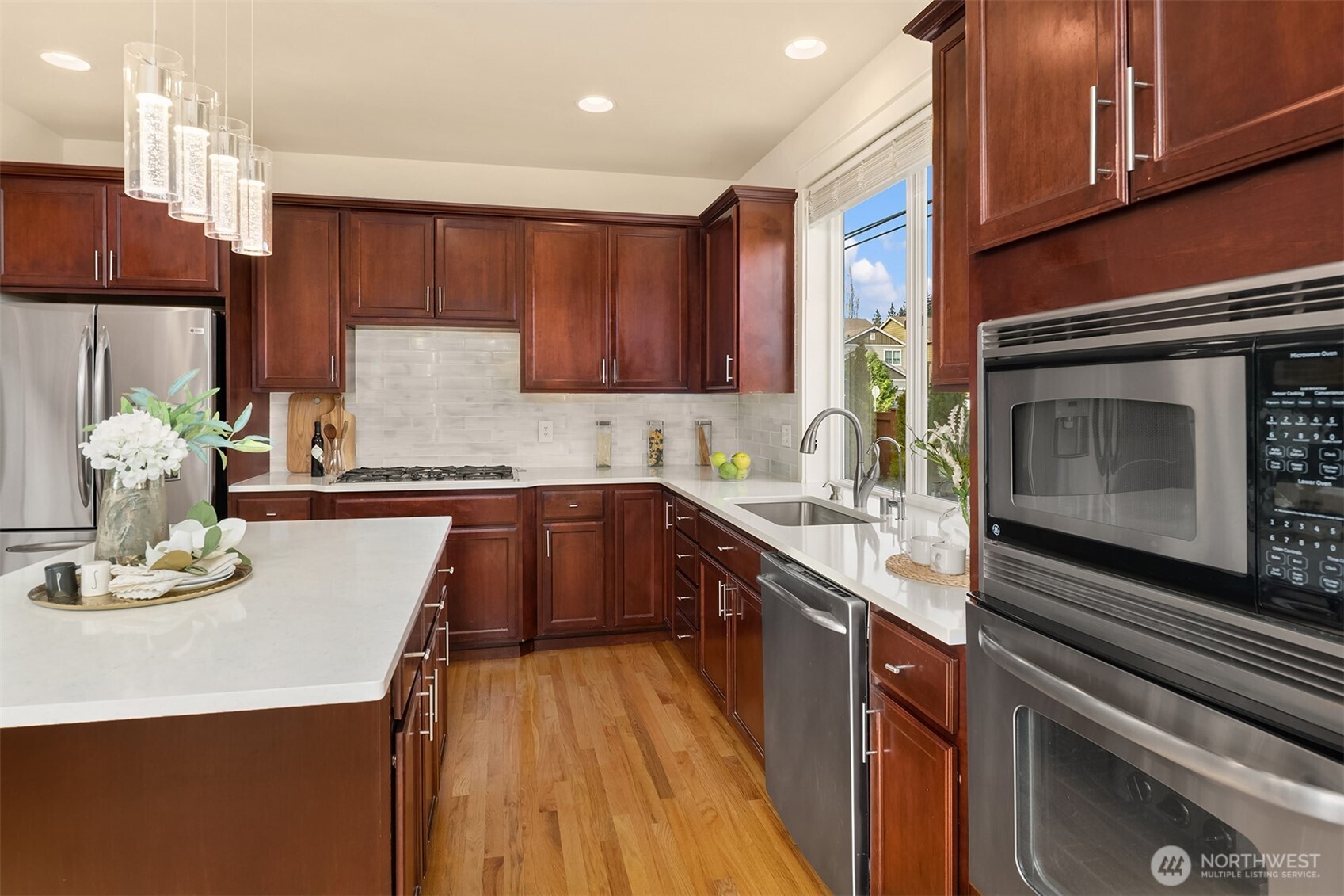 4106 167th Place Southeast Bothell, WA 98012 - Photo 16 of 35 a kitchen with kitchen island granite countertop a sink cabinets and stainless steel appliances