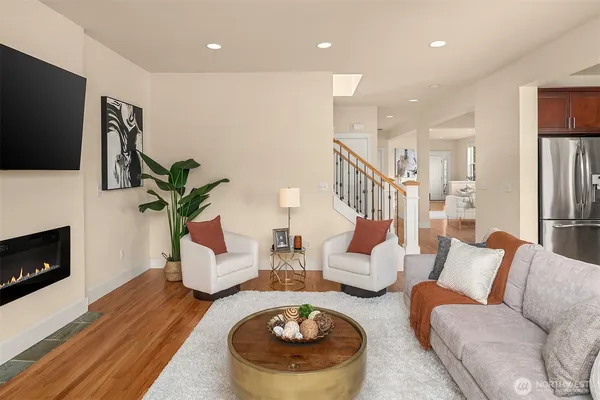 a living room with furniture a fireplace and a flat screen tv