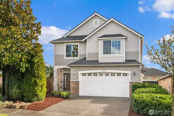 a front view of a house with a yard and garage