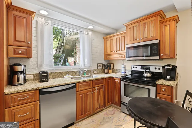 a kitchen with a sink stove top oven and microwave