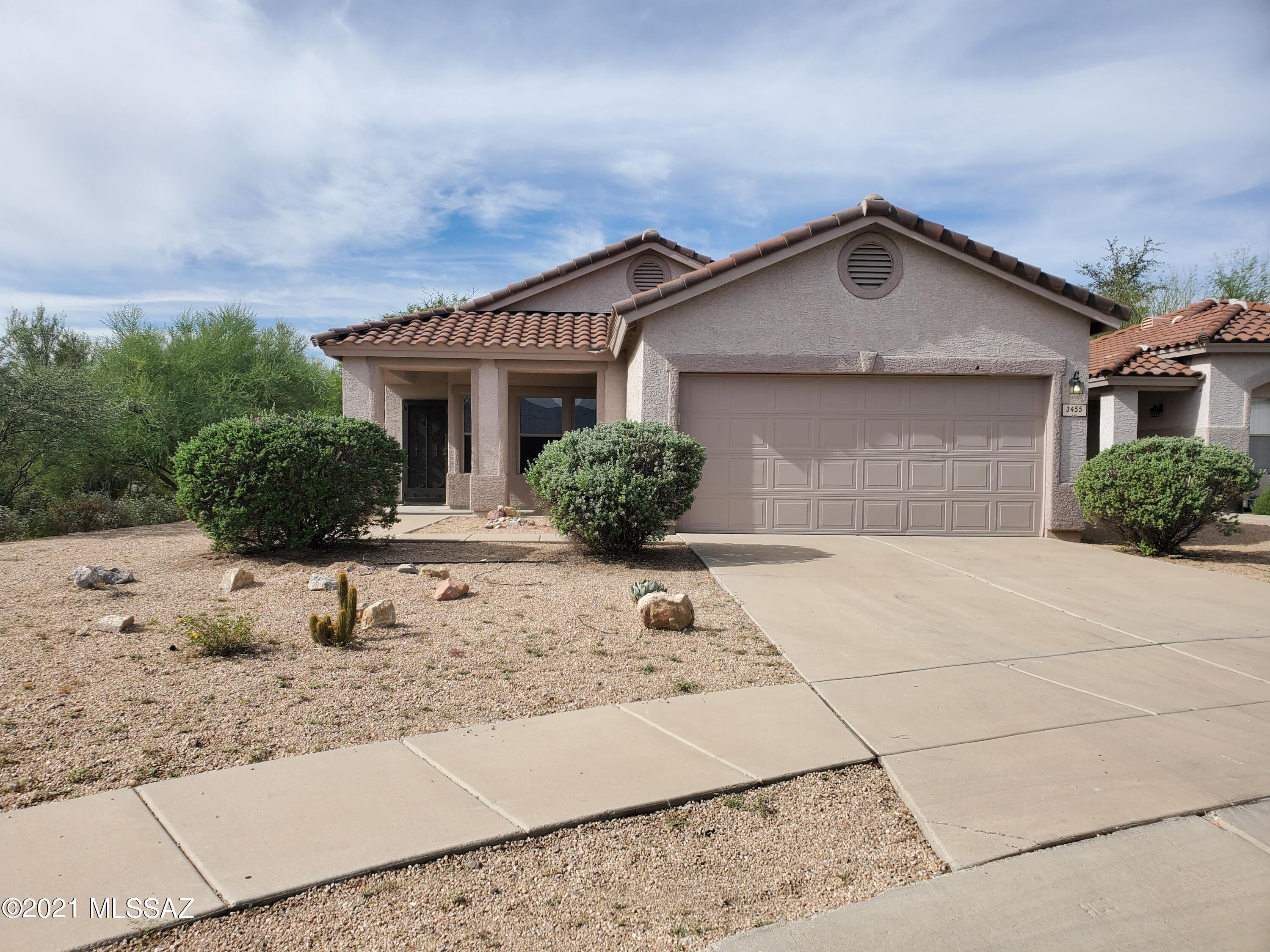 3455 North Boyce Spring Lane Tucson, AZ 85745 - Photo 1 of 21 a front view of a house with a yard