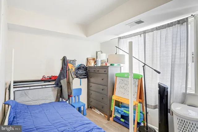 a view of a kitchen with fridge and wooden floor