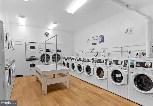 a utility room with dryer washer and other items
