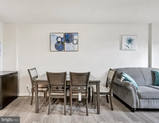 a view of a livingroom with furniture and a dining table