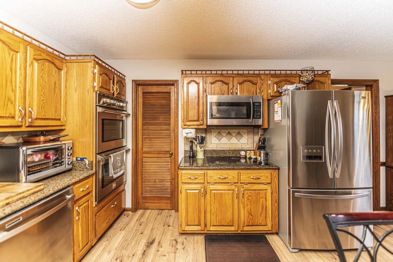 3899 Kerr Road Millington, TN 38053 - Photo 13 of 25 a kitchen with stainless steel appliances granite countertop a refrigerator and a stove top oven