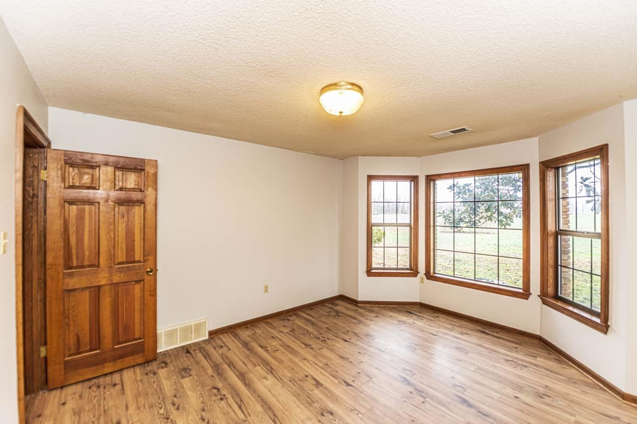 3899 Kerr Road Millington, TN 38053 - Photo 18 of 25 wooden floor in an empty room with a window