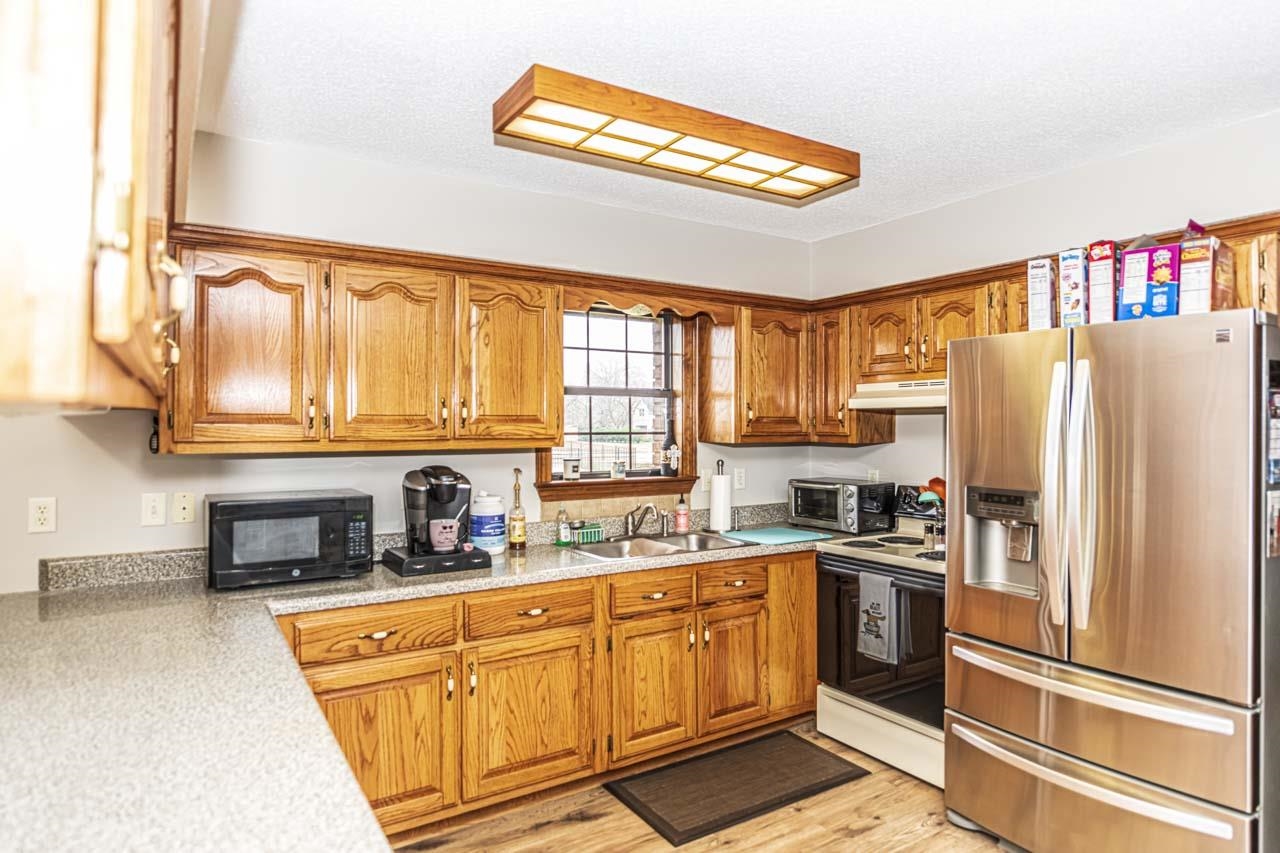 3899 Kerr Road Millington, TN 38053 - Photo 21 of 25 a kitchen with stainless steel appliances a refrigerator sink and cabinets