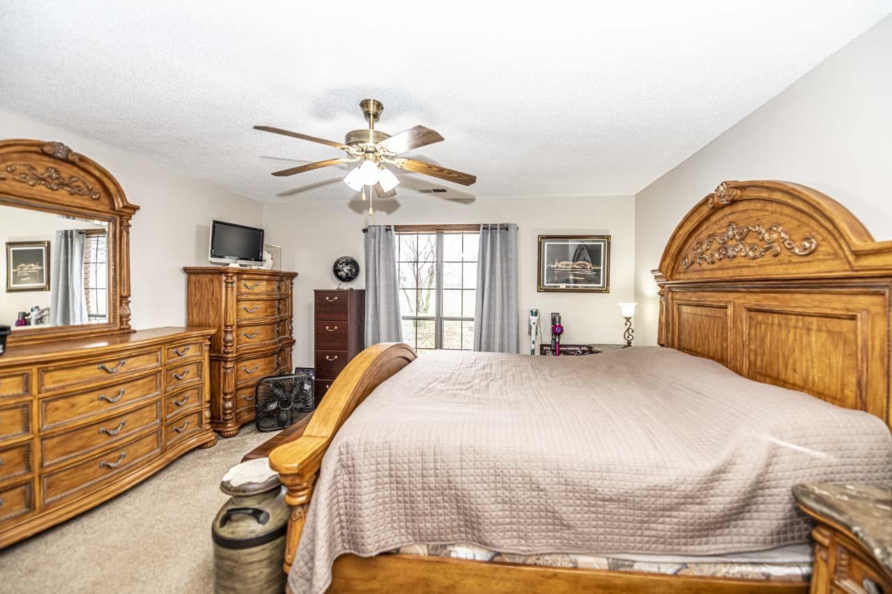 3899 Kerr Road Millington, TN 38053 - Photo 22 of 25 a bedroom with a bed and a chandelier