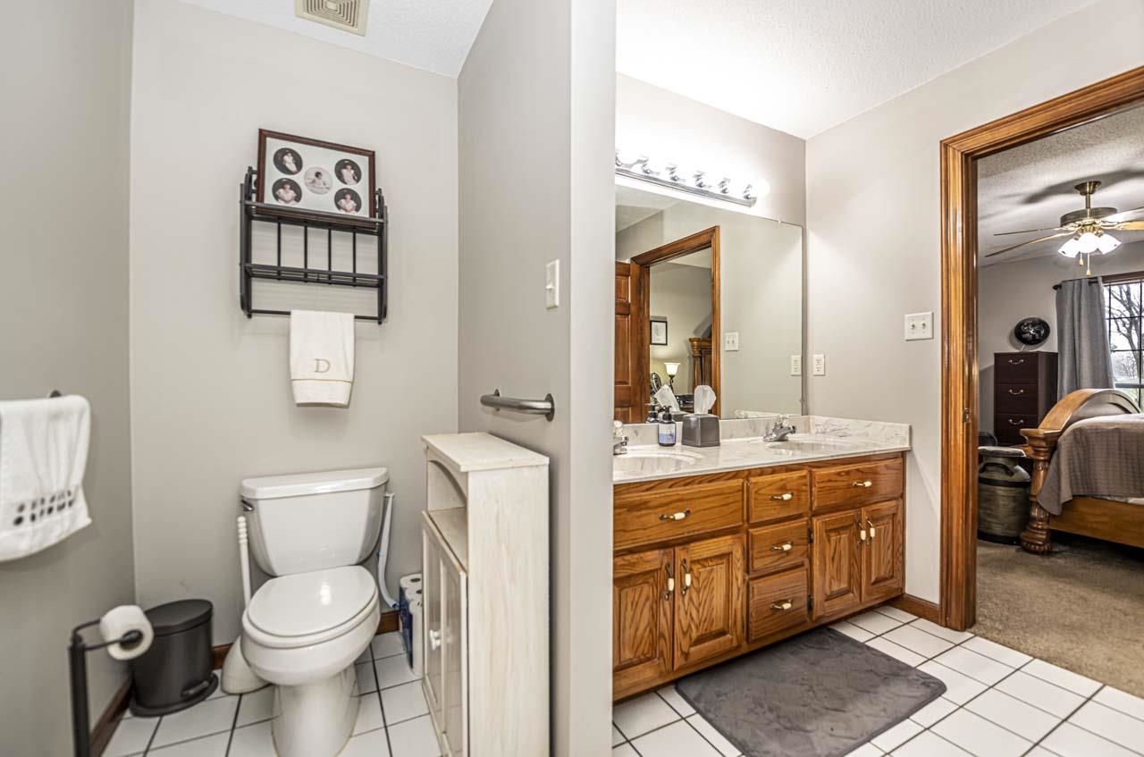 3899 Kerr Road Millington, TN 38053 - Photo 23 of 25 a bathroom with a toilet a sink and a mirror