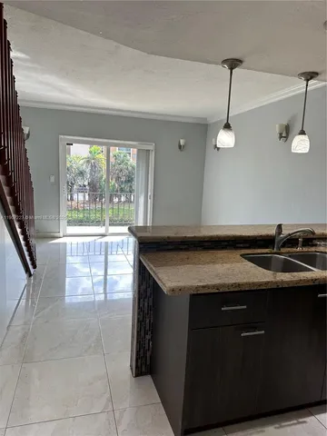 a kitchen with a sink a stove and a refrigerator