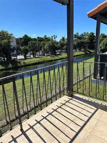 a view of balcony with a couple of chairs