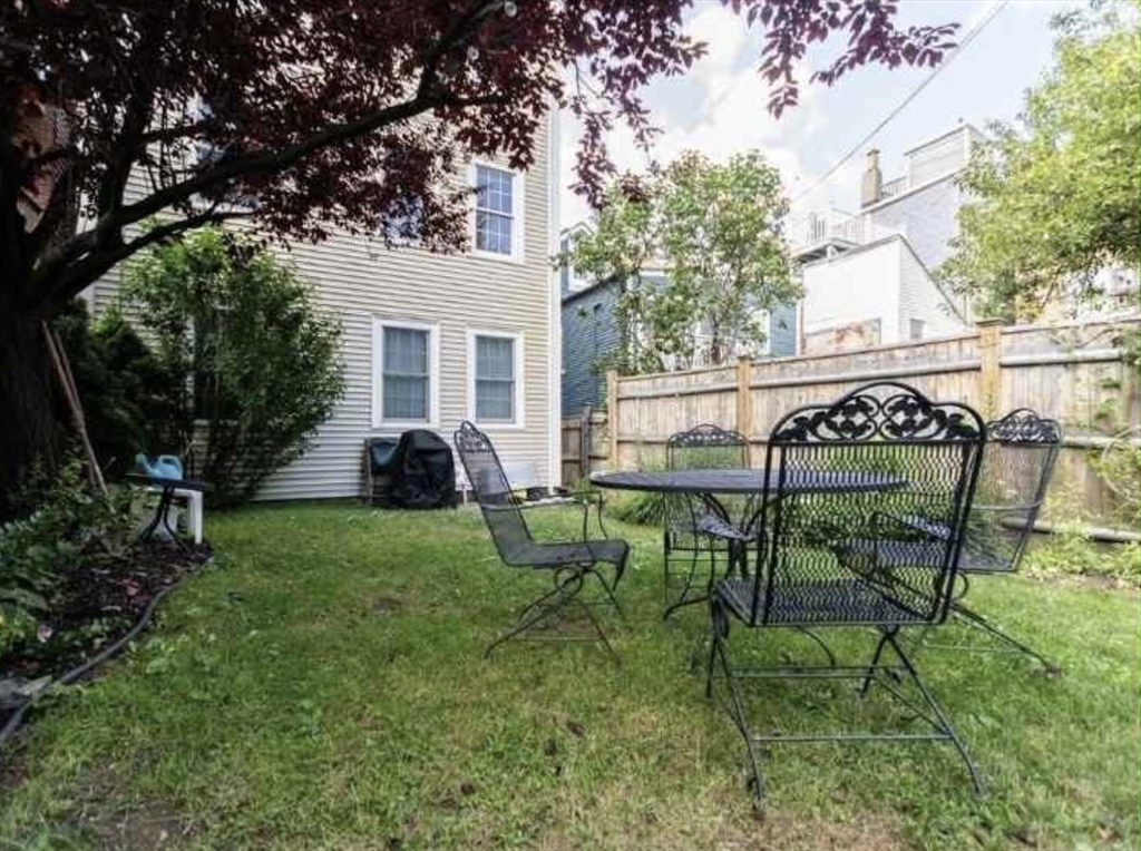 34 Austin Street, Unit 2 Boston, MA 02129 - Photo 4 of 19 a view of a chair and table in backyard