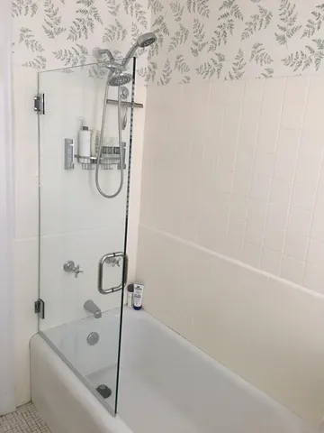 a bathroom with a bathtub and shower