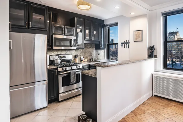 a kitchen with stainless steel appliances and refrigerator