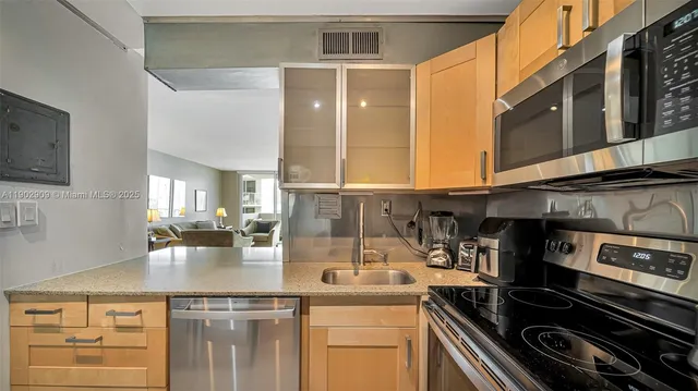 a kitchen with a sink and cabinets