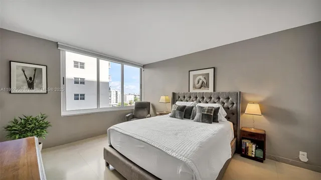 a bedroom with a large bed and a window