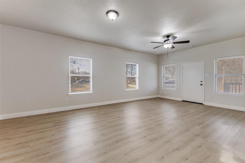 711 South 3rd Avenue East Dawson, TX 76639 - Photo 4 of 12 a view of an empty room with a window and wooden floor