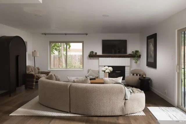 a living room with furniture and a fireplace