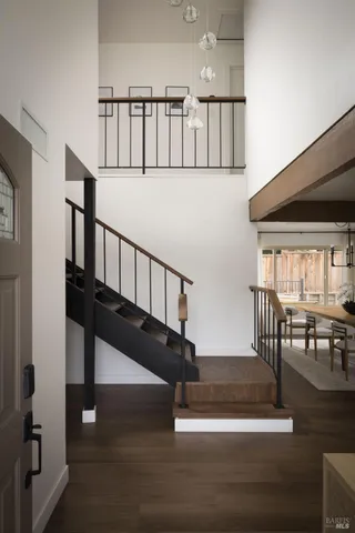 a view of entryway livingroom and hall with wooden floor