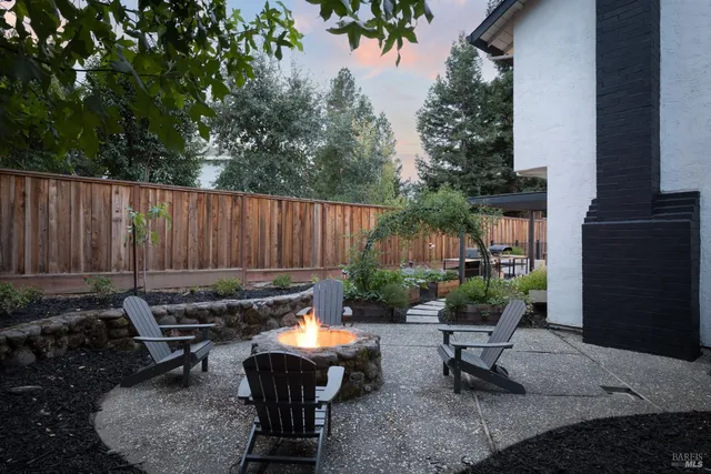 a backyard of a house with yard fire pit and outdoor seating