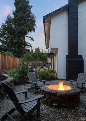 a view of a house with backyard swimming pool and furniture
