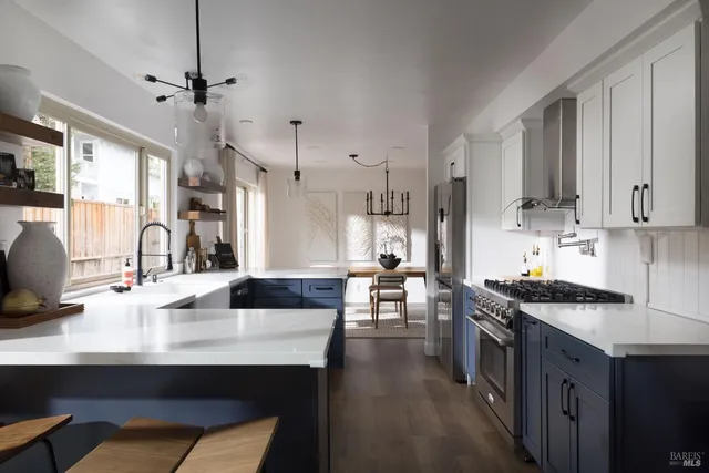 a kitchen with stainless steel appliances a sink a stove and a refrigerator