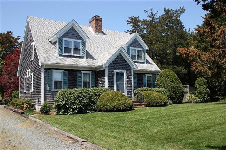 52 Cedar Land Road Orleans, MA 02653 - Photo 1 of 16 a front view of a house with a garden