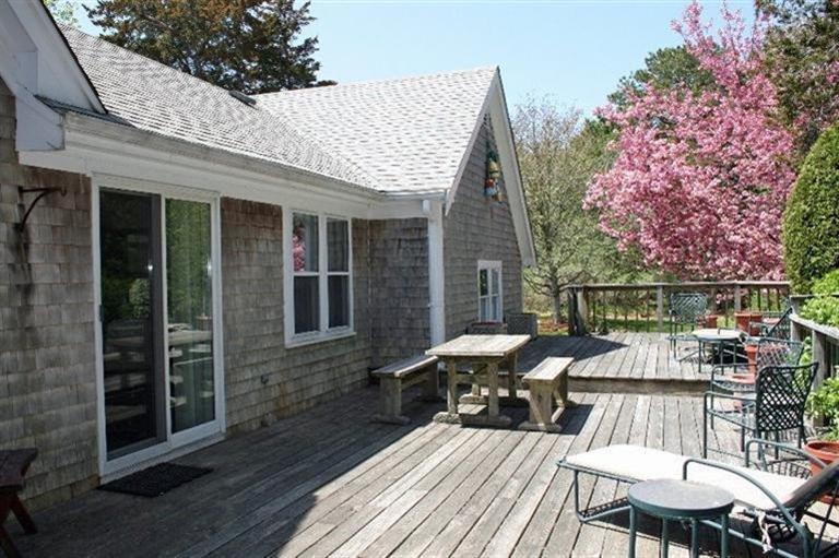 52 Cedar Land Road Orleans, MA 02653 - Photo 3 of 16 a view of a patio with table and chairs and wooden floor
