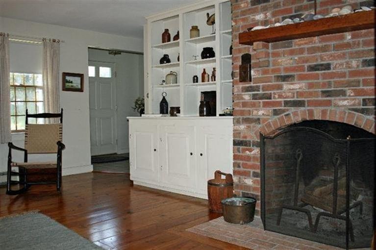 52 Cedar Land Road Orleans, MA 02653 - Photo 9 of 16 a living room with furniture and a fireplace