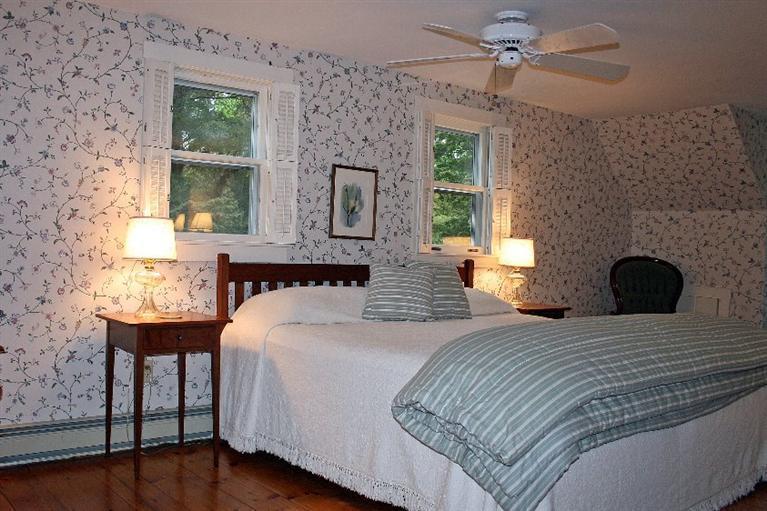 52 Cedar Land Road Orleans, MA 02653 - Photo 10 of 16 a bedroom with a bed and a table
