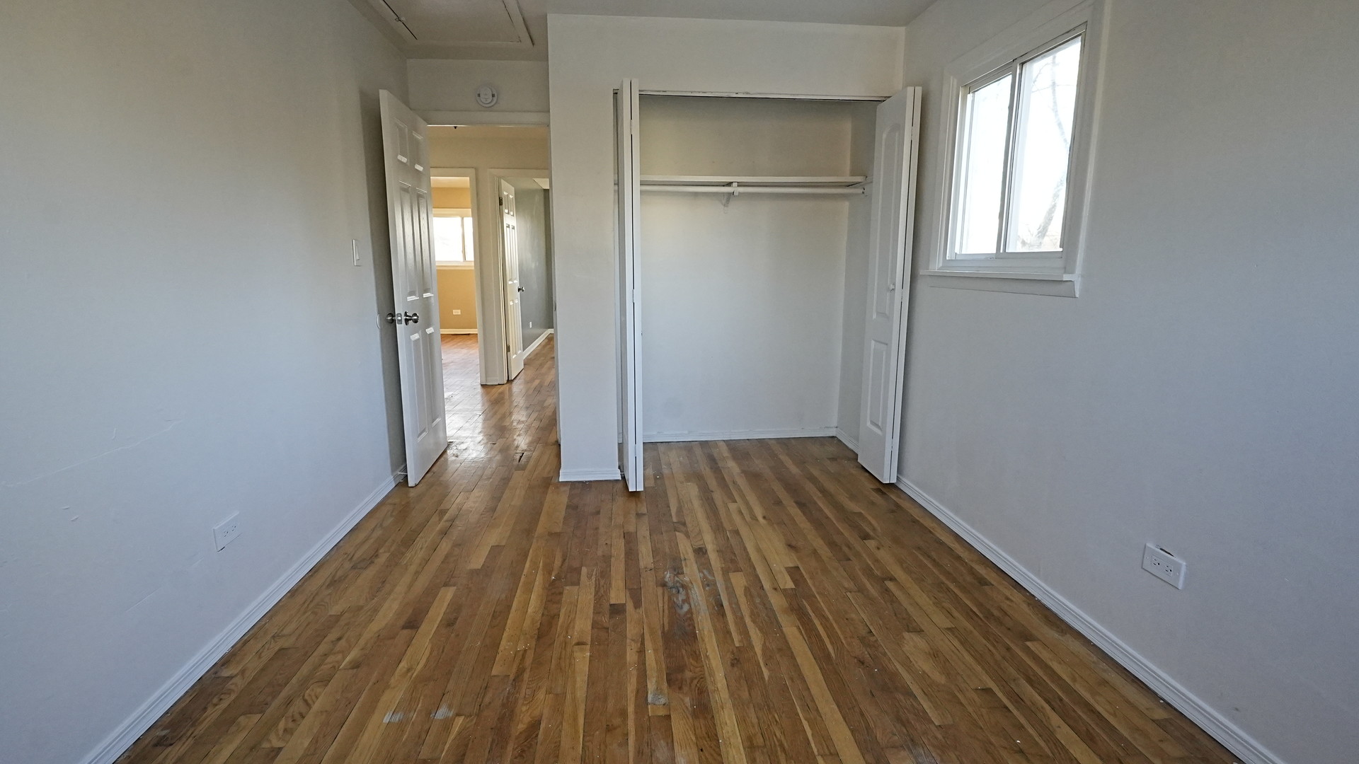 16918 Orchard Ridge Avenue Hazel Crest, IL 60429 - Photo 16 of 21 a view of a room with wooden floor and a window
