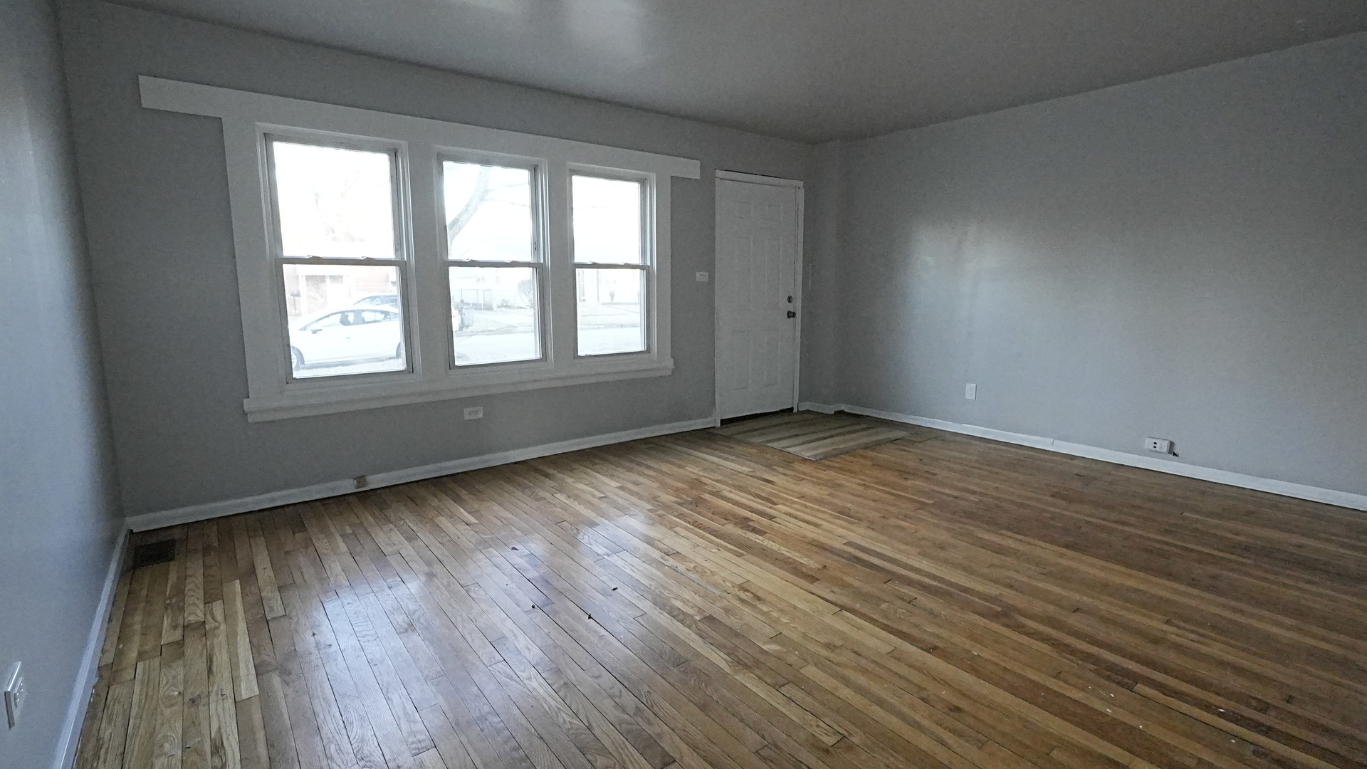 16918 Orchard Ridge Avenue Hazel Crest, IL 60429 - Photo 4 of 21 an empty room with wooden floor and windows