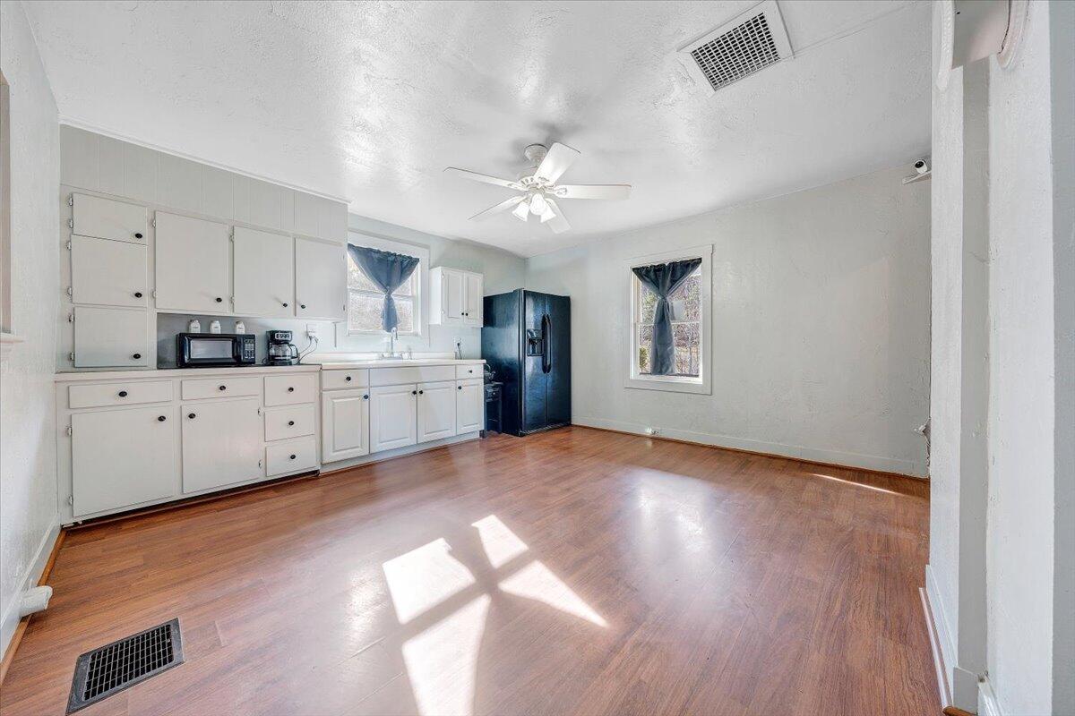 6702 Ferrum Mountain Road Callaway, VA 24067 - Photo 11 of 45 a view of a kitchen with a sink dishwasher a refrigerator with wooden floors