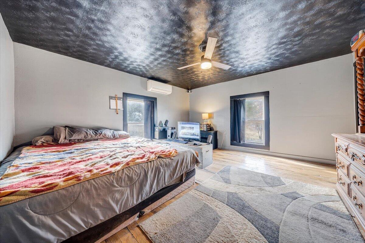 6702 Ferrum Mountain Road Callaway, VA 24067 - Photo 22 of 45 a bedroom with a large bed and a chandelier