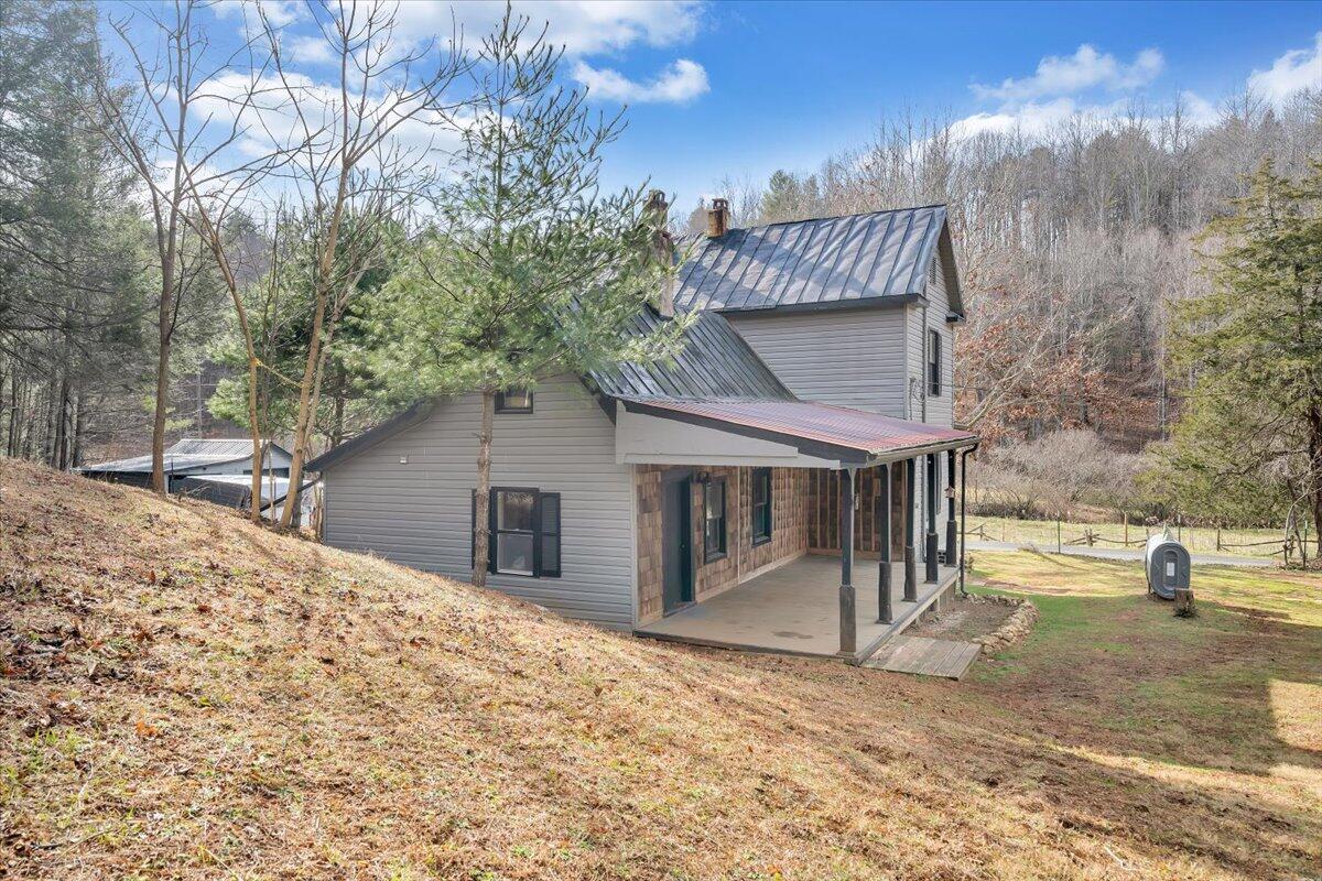 6702 Ferrum Mountain Road Callaway, VA 24067 - Photo 35 of 45 a view of a house with a yard and sitting area