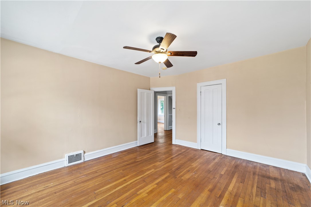 3076 Yorkshire Road Cleveland, OH 44118 - Photo 19 of 47 Empty room featuring wood-type flooring and ceiling fan