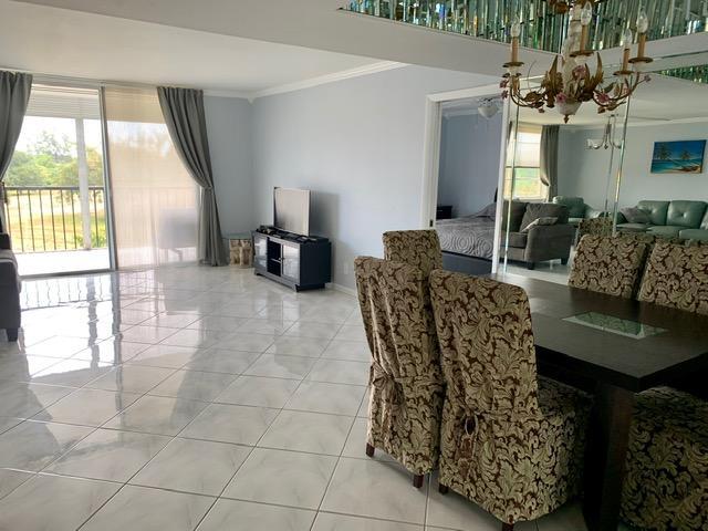 6400 Northwest 2nd Avenue, Unit 417 Boca Raton, FL 33487 - Photo 11 of 66 a living room with furniture and a large window