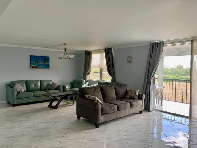 6400 Northwest 2nd Avenue, Unit 417 Boca Raton, FL 33487 - Photo 15 of 66 a living room with furniture and a large window