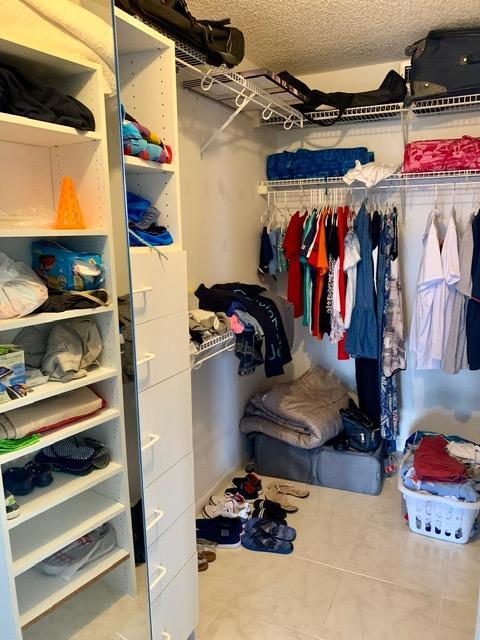 6400 Northwest 2nd Avenue, Unit 417 Boca Raton, FL 33487 - Photo 18 of 66 a view of walk in closet with clothes and shoes