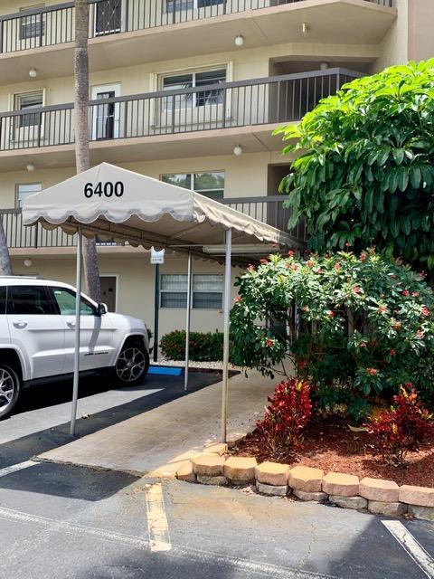 6400 Northwest 2nd Avenue, Unit 417 Boca Raton, FL 33487 - Photo 2 of 66 a view of a cars park in front of a building