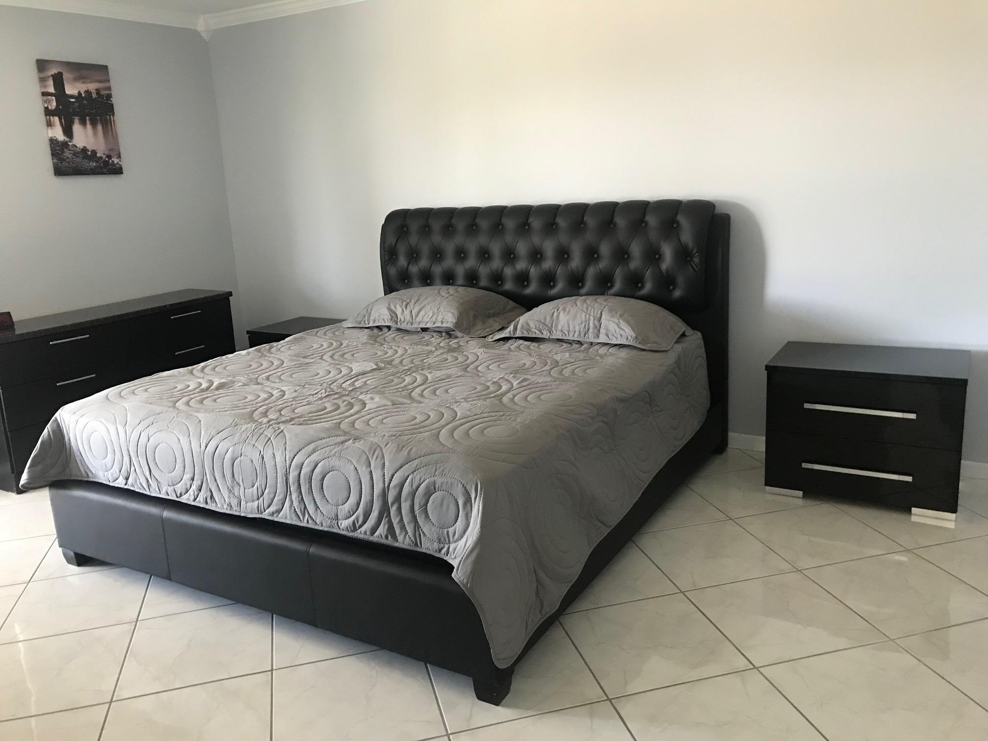 6400 Northwest 2nd Avenue, Unit 417 Boca Raton, FL 33487 - Photo 22 of 66 a bedroom with a bed and a rug