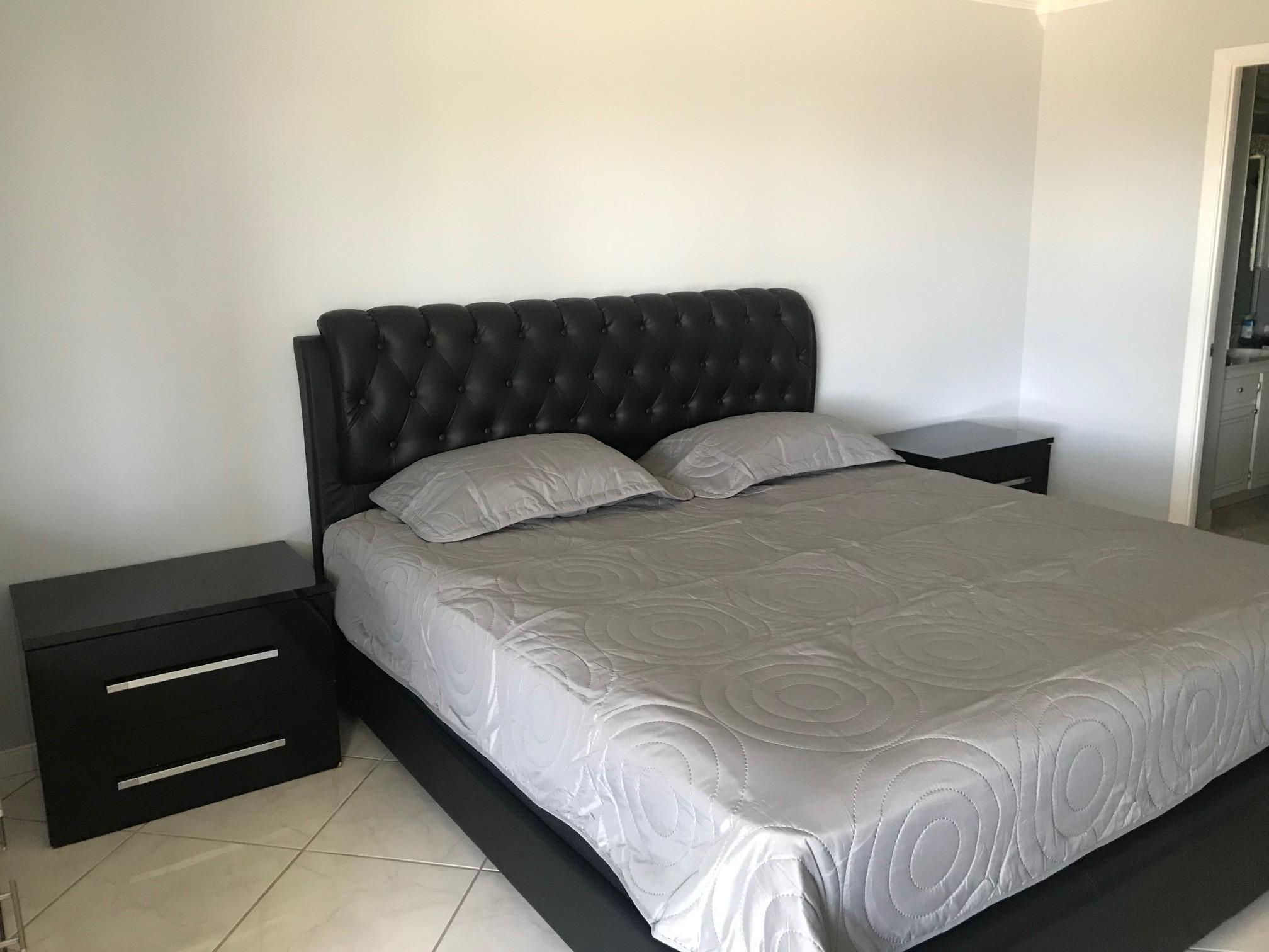 6400 Northwest 2nd Avenue, Unit 417 Boca Raton, FL 33487 - Photo 24 of 66 a bedroom with a bed and a chair