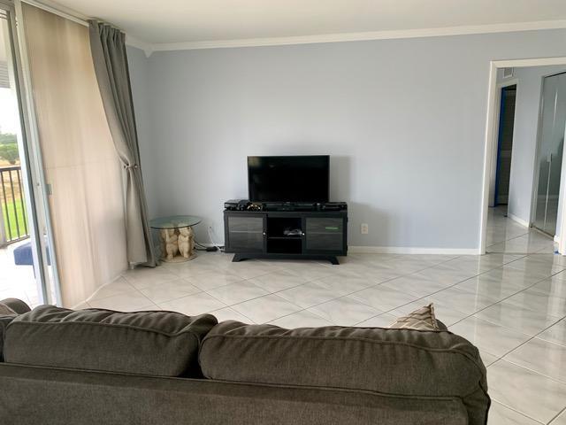 6400 Northwest 2nd Avenue, Unit 417 Boca Raton, FL 33487 - Photo 25 of 66 a living room with furniture and a flat screen tv
